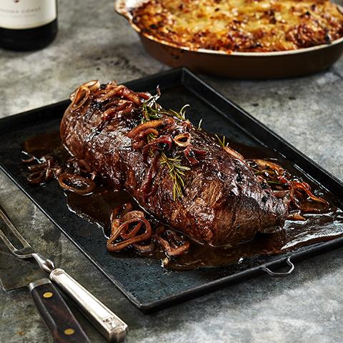 A plate of roast beef tenderloin with red wine glaze.